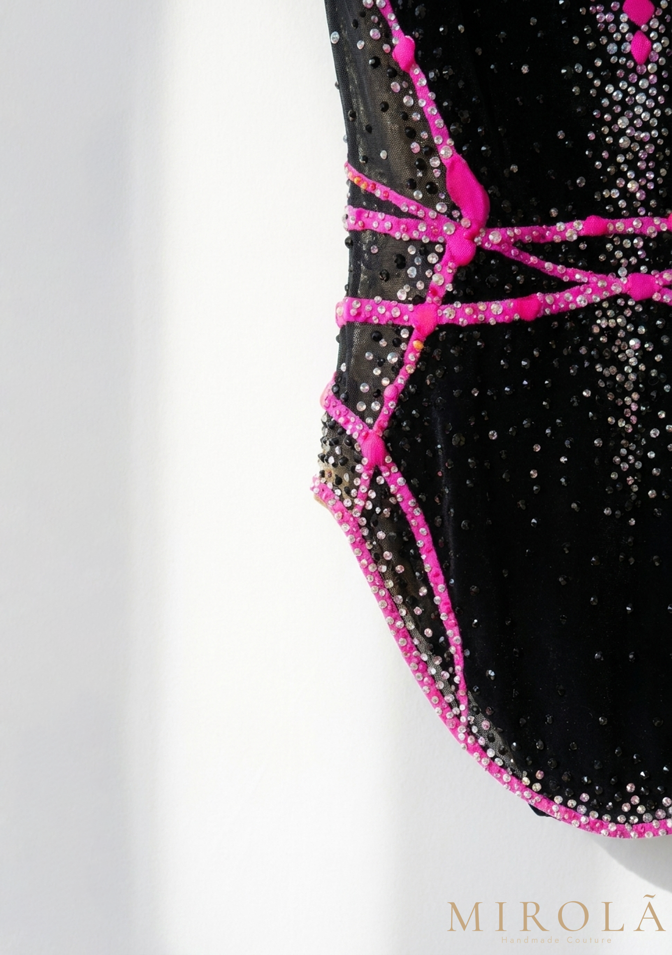 Fuchsia rhythmic gymnastics competition leotard — shoulder detail